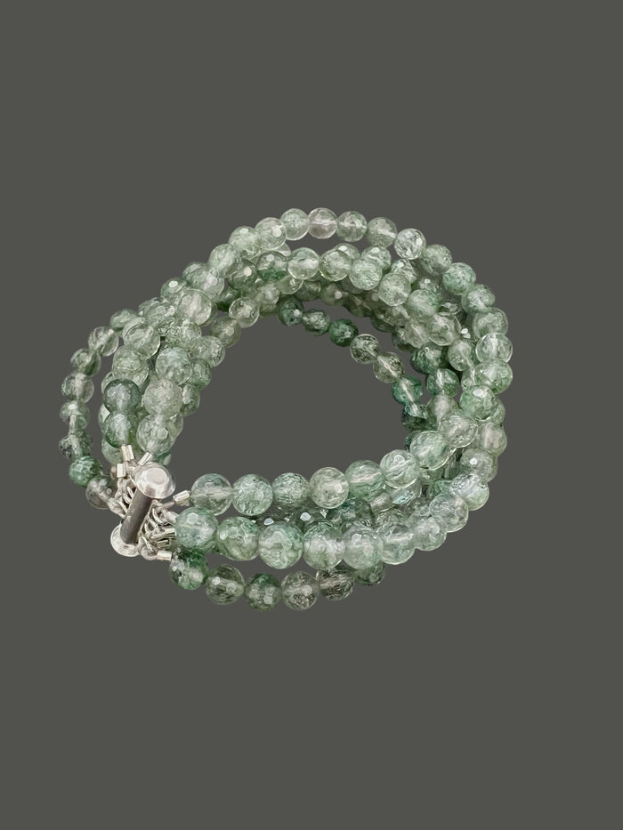 The ANN LIGHTFOOT "Five Strand Green Quartz Bracelet" features coiled, round translucent green beads with a crackled texture, fastened by a stainless steel clasp against a plain white background.