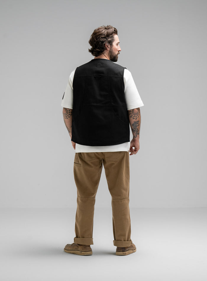 Max Is 5ft 8" And Wears Size: M | Hem Studio Image Of Model Wearing Dissident Utility Vest In Obsidian Black (SS Model)