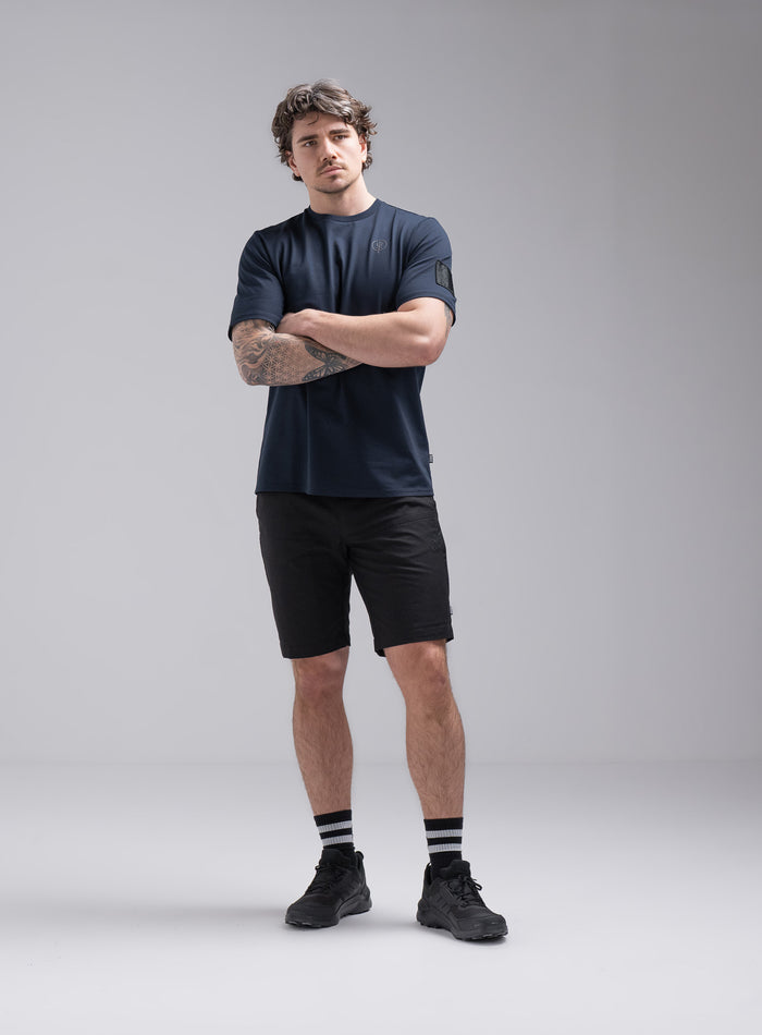 Jack Is 6ft 3" And Wears Size: L | Hem Studio Image Of Model Wearing Insignia Short Sleeve T-Shirt In Dark Sapphire (SS Model)
