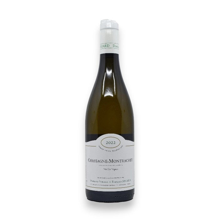 A bottle of WINE: ORSINI JOUARD CHASSAGNE-MONTRACHET 2023 stands upright against a white background, featuring the wine name and vintage on its label, and a white foil wraps the neck of the bottle.