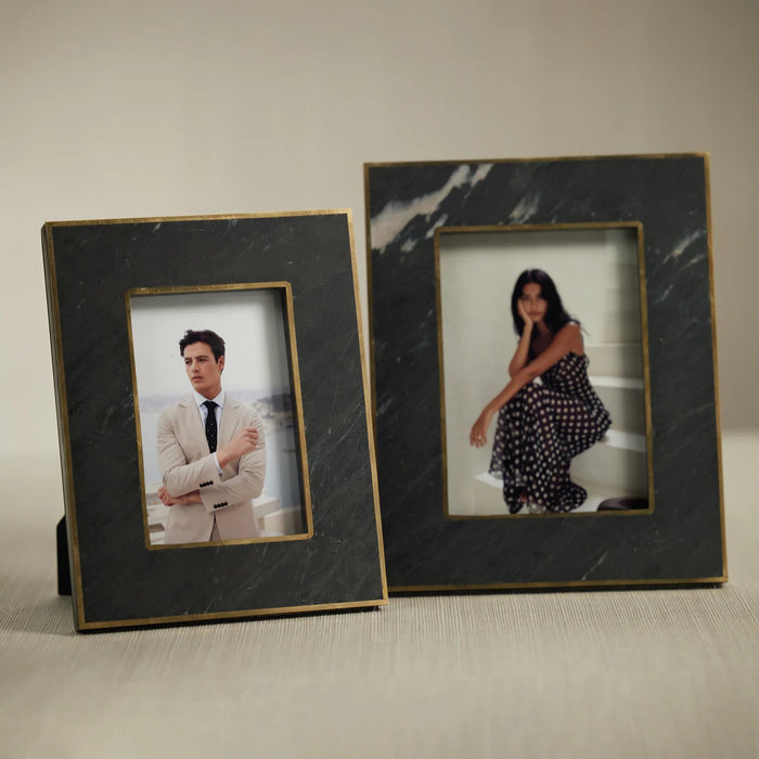 The ZODAX RENNES GRANITE PHOTO FRAME 4x6, featuring a dark stone-like border and gold trim, showcases a man's portrait in a beige suit and tie set before a blurred outdoor background.