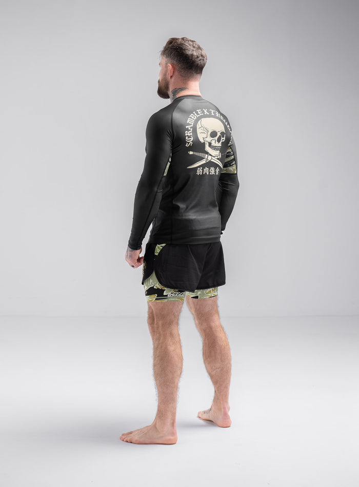 Staz Is 5ft 8" And Wears Size: S | Hem Studio Image Of Model Wearing Thrudark X Scramble Long Sleeve Rash Guard In Obsidian Black (SS Model)