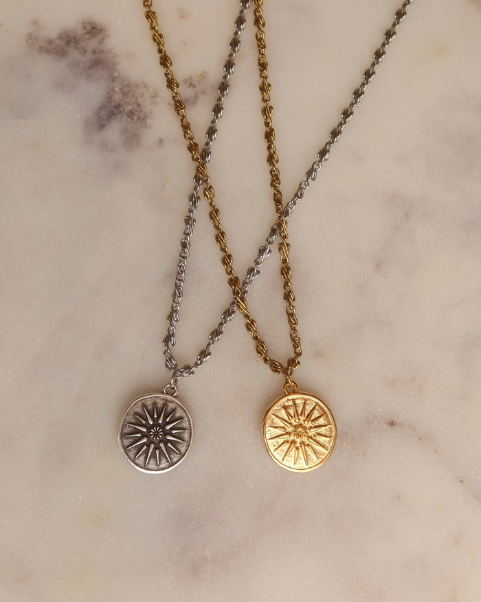 A gold and a silver coin necklace with sun symbols, ancient Greek coin necklaces