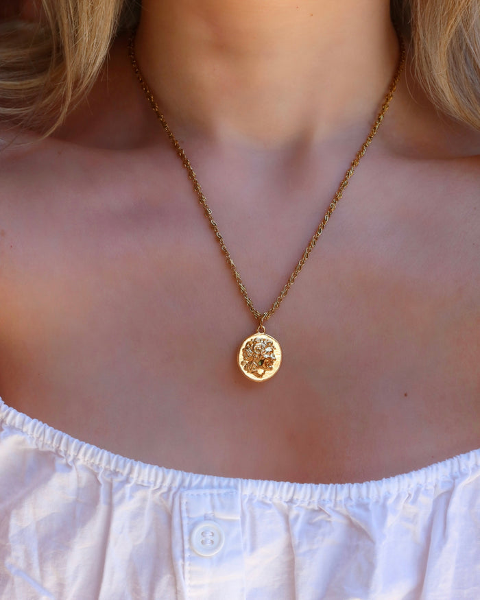 Woman wearing a gold Alexander the Great Greek coin necklace on an infinity chain, Greek coin jewelry