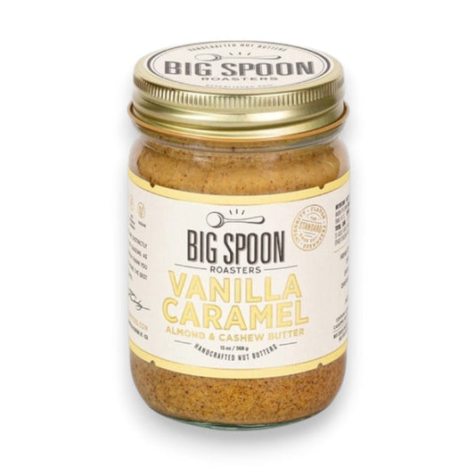 A 13 oz (368g) glass jar of BIG SPOON ROASTERS Vanilla Caramel Almond & Cashew Butter features a gold lid and cream label, and contains handcrafted, refined sugar free, vegan nut butter from BIG SPOON ROASTERS.