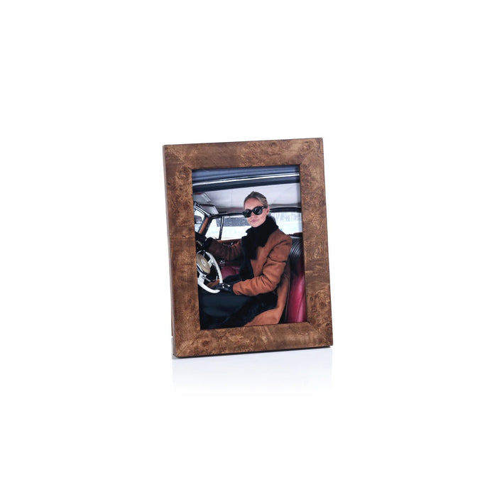 Three wooden photo frames, including the ZODAX BURL WOOD PHOTO FRAME 5X7, are shown on a light surface holding photos of a woman driving in sunglasses, another in a hat and coat, and a close-up of someone in a suit.