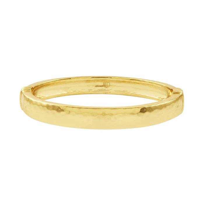 The CAPUCINE DE WULF - CLEOPATRA OVAL HINGED BANGLE SMALL/MEDIUM is a polished, hammered gold bracelet, expertly handcrafted by CAPUCINE DE WULF and displayed against a plain white background.