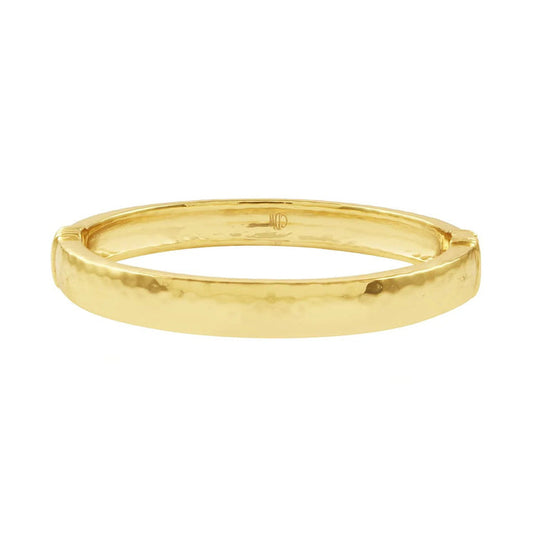 The CAPUCINE DE WULF - CLEOPATRA OVAL HINGED BANGLE SMALL/MEDIUM is a polished, hammered gold bracelet, expertly handcrafted by CAPUCINE DE WULF and displayed against a plain white background.