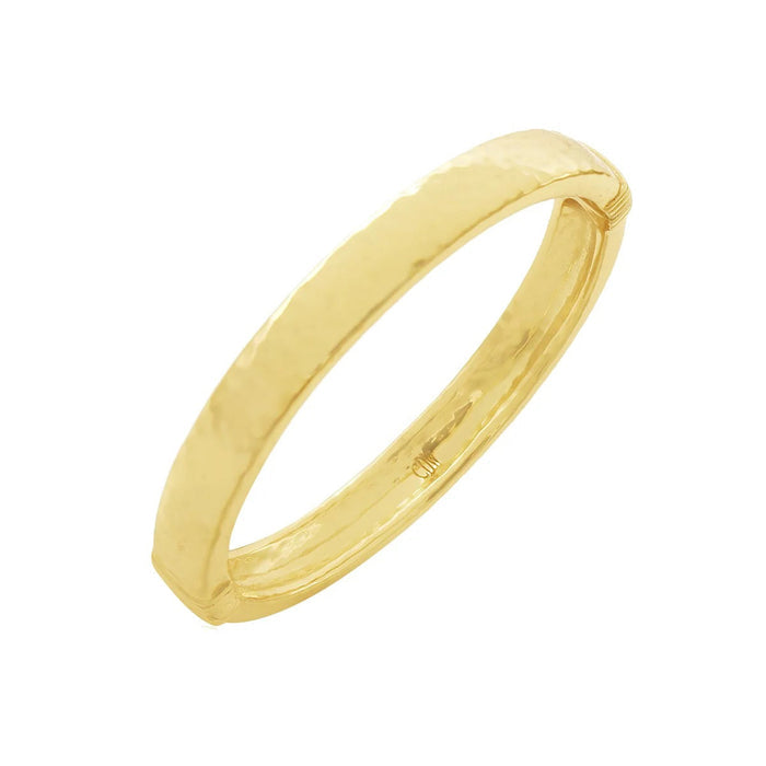 The CAPUCINE DE WULF - CLEOPATRA OVAL HINGED BANGLE SMALL/MEDIUM is a polished, hammered gold bracelet, expertly handcrafted by CAPUCINE DE WULF and displayed against a plain white background.