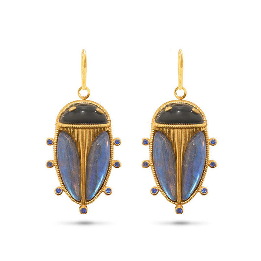 The CAPUCINE DE WULF Scarab Petite Drop Blue Labradorite/Black Agate Earrings feature beetle-inspired designs with black and blue stones and six blue gems—unique statement jewelry for a striking look.