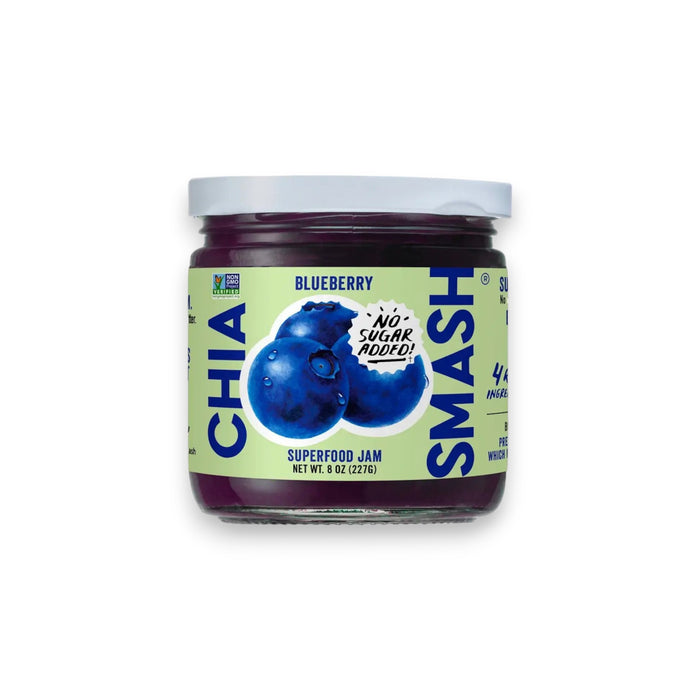 A jar of CHIA SMASH - BLUEBERRY CHIA JAM from the brand CHIA SMASH features a label with two illustrated blueberries and the text "No Sugar Added!" This 8 oz (227g) jar proudly displays its "Non-GMO Project Verified" status and contains just 4 ingredients, making it an ideal zero added sugar jam that is both paleo and vegan friendly.