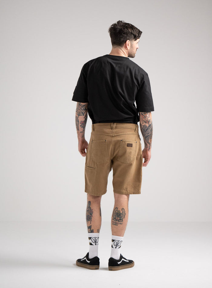 Bernie Is 6ft And Wears Size: M | Hem Studio Image Of Model Wearing Dissident Canvas Shorts In Coyote Brown (SS Model)