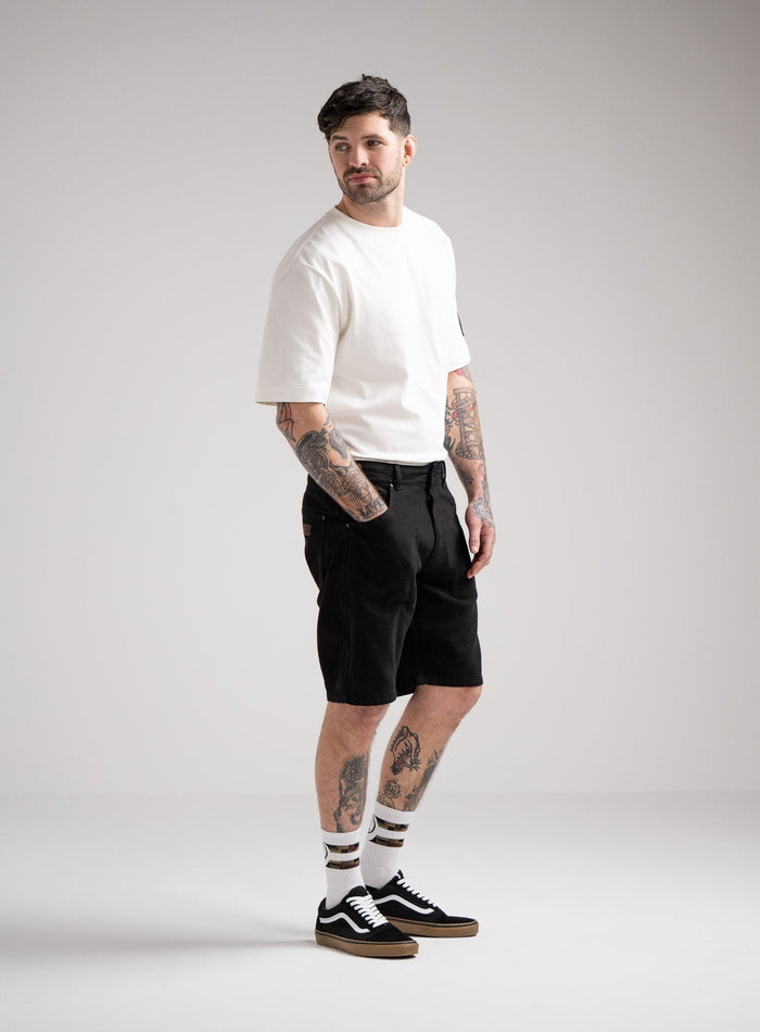 Bernie Is 6ft And Wears Size: M | Hem Studio Image Of Model Wearing Dissident Canvas Shorts In Obsidian Black (SS Model)