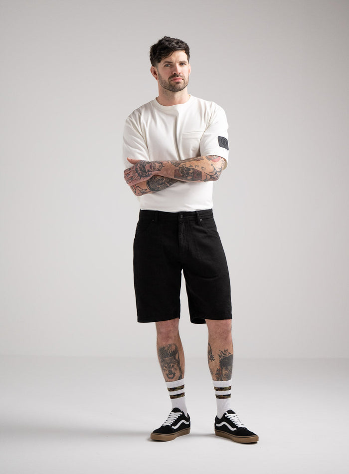 Bernie Is 6ft And Wears Size: M | Hem Studio Image Of Model Wearing Dissident Canvas Shorts In Obsidian Black (SS Model)