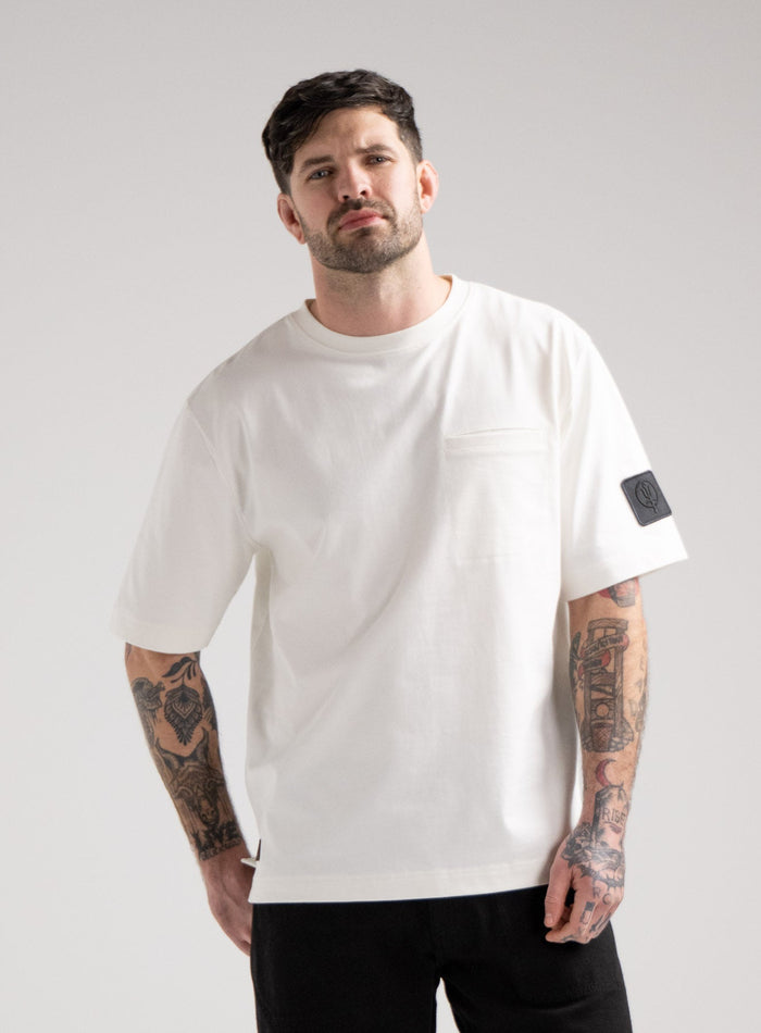 Bernie Is 6ft And Wears Size: M | Hem Studio Image Of Model Wearing Dissident Heavy T-Shirt In Optic White (SS Model)