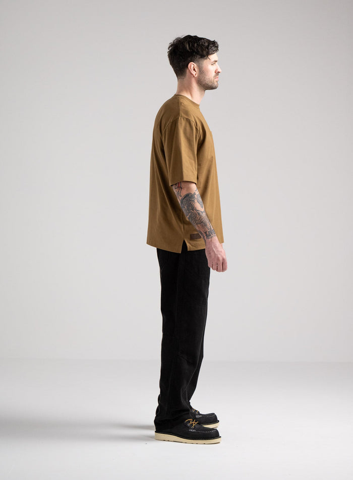 Bernie Is 6ft And Wears Size: M | Hem Studio Image Of Model Wearing Dissident Heavy T-Shirt In Coyote Brown (SS Model)