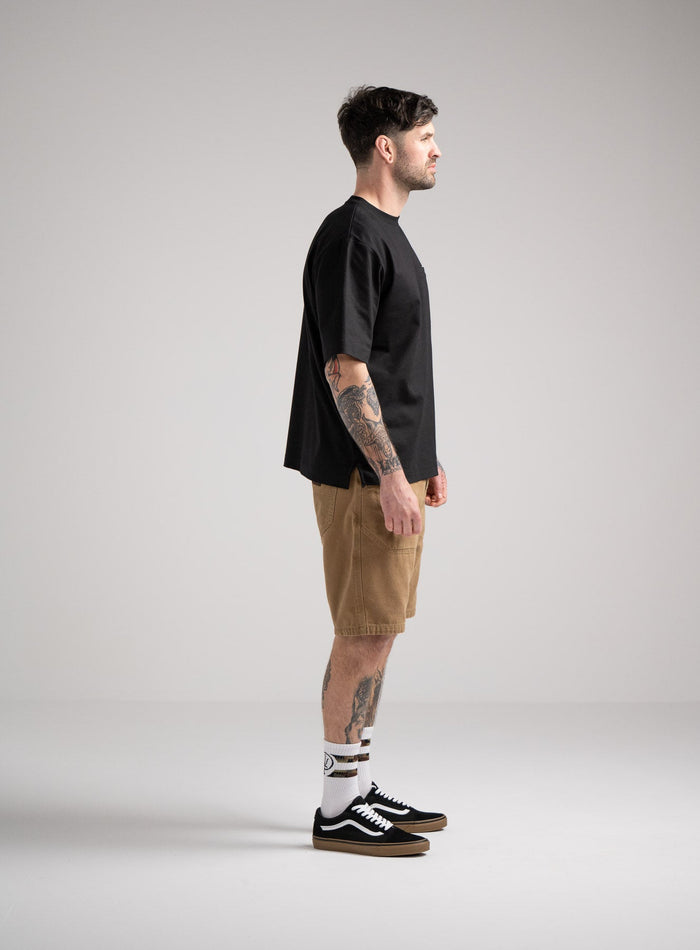 Bernie Is 6ft And Wears Size: M | Hem Studio Image Of Model Wearing Dissident Heavy T-Shirt In Obsidian Black (SS Model)
