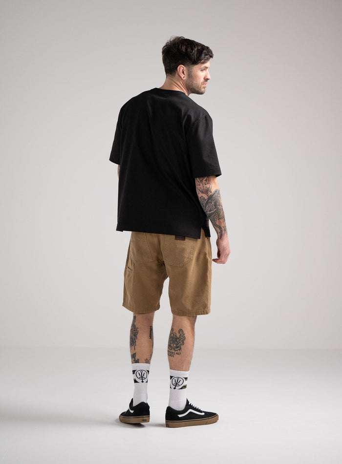 Bernie Is 6ft And Wears Size: M | Hem Studio Image Of Model Wearing Dissident Heavy T-Shirt In Obsidian Black (SS Model)