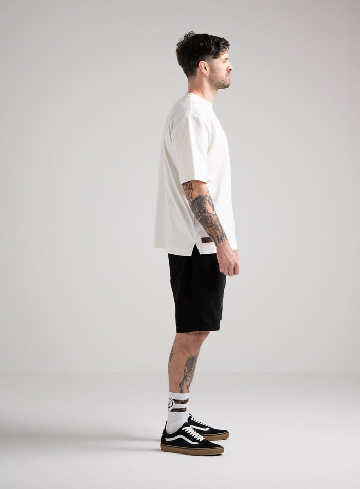 Bernie Is 6ft And Wears Size: M | Hem Studio Image Of Model Wearing Dissident Heavy T-Shirt In Optic White (SS Model)