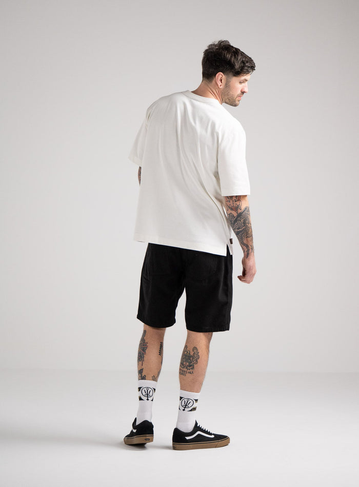 Bernie Is 6ft And Wears Size: M | Hem Studio Image Of Model Wearing Dissident Heavy T-Shirt In Optic White (SS Model)