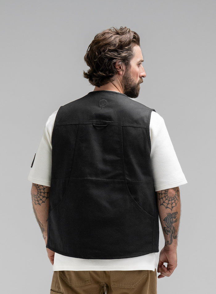 Max Is 5ft 8" And Wears Size: M | Hem Studio Image Of Model Wearing Dissident Utility Vest In Obsidian Black (SS Model)