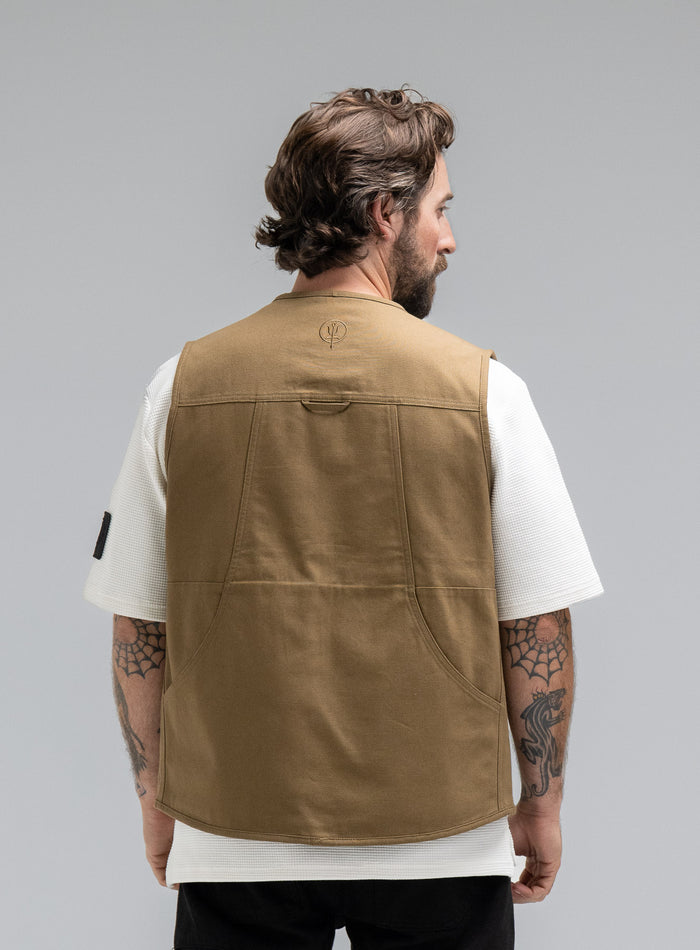 Max Is 5ft 8" And Wears Size: M | Hem Studio Image Of Model Wearing Dissident Utility Vest In Coyote Brown (SS Model)