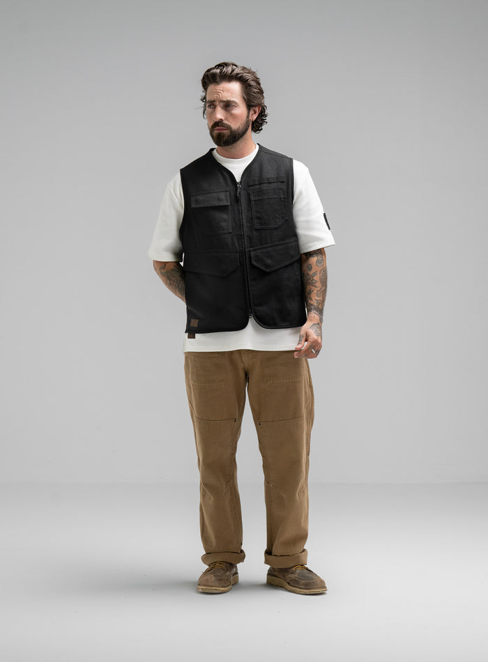 Max Is 5ft 8" And Wears Size: M | Hem Studio Image Of Model Wearing Dissident Utility Vest In Obsidian Black (SS Model)