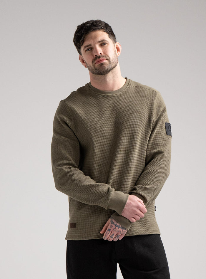 Bernie Is 6ft And Wears Size: M | Hem Studio Image Of Model Wearing Dissident Waffle Long Sleeve T-Shirt In Khaki (SS Model)