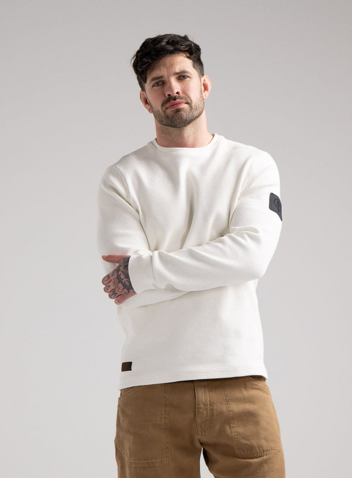 Bernie Is 6ft And Wears Size: M | Hem Studio Image Of Model Wearing Dissident Waffle Long Sleeve T-Shirt In Optic White (SS Model)