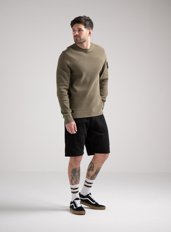 Bernie Is 6ft And Wears Size: M | Hem Studio Image Of Model Wearing Dissident Waffle Long Sleeve T-Shirt In Khaki (SS Model)