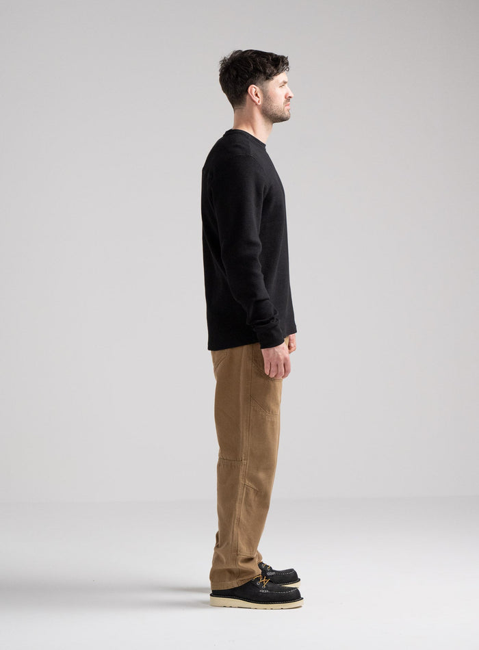 Bernie Is 6ft And Wears Size: M | Hem Studio Image Of Model Wearing Dissident Waffle Long Sleeve T-Shirt In Obsidian Black (SS Model)