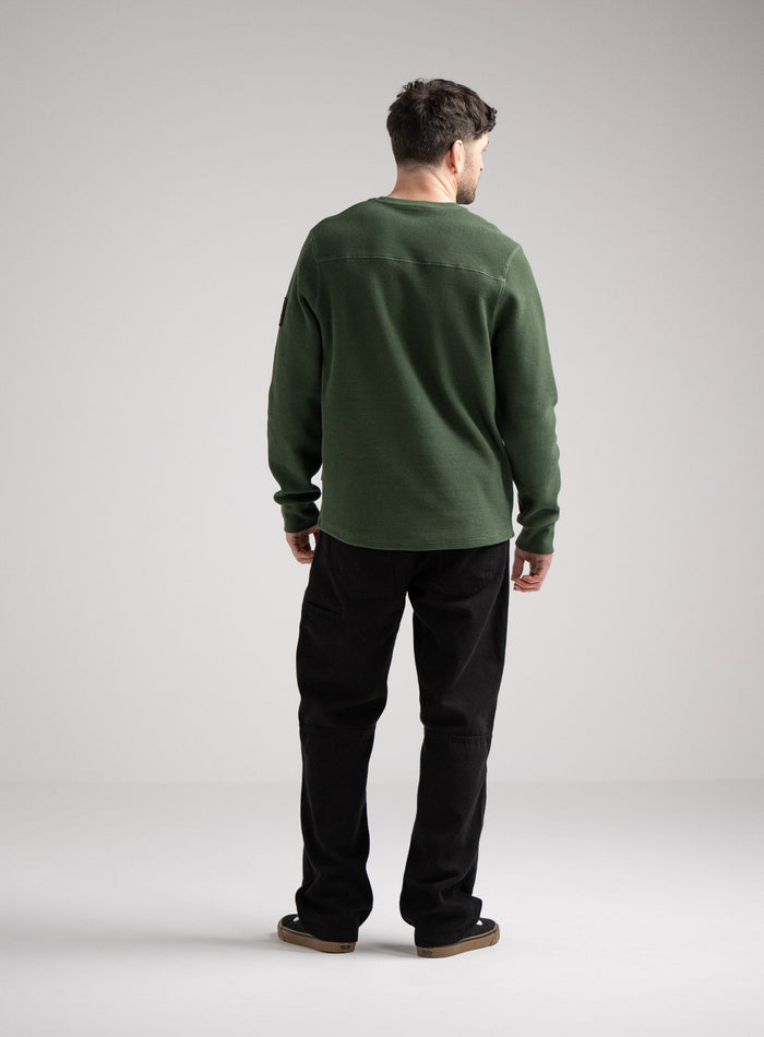 Bernie Is 6ft And Wears Size: M | Hem Studio Image Of Model Wearing Dissident Waffle Long Sleeve T-Shirt In Forest Green (SS Model)