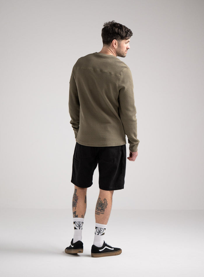 Bernie Is 6ft And Wears Size: M | Hem Studio Image Of Model Wearing Dissident Waffle Long Sleeve T-Shirt In Khaki (SS Model)