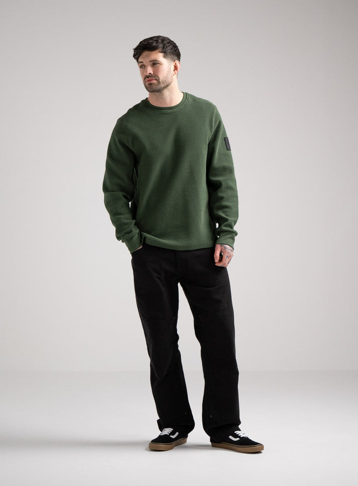 Bernie Is 6ft And Wears Size: M | Hem Studio Image Of Model Wearing Dissident Waffle Long Sleeve T-Shirt In Forest Green (SS Model)