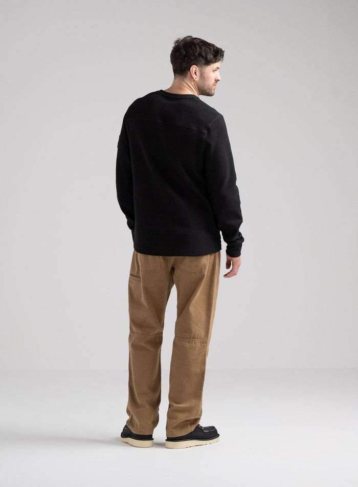 Bernie Is 6ft And Wears Size: M | Hem Studio Image Of Model Wearing Dissident Waffle Long Sleeve T-Shirt In Obsidian Black (SS Model)