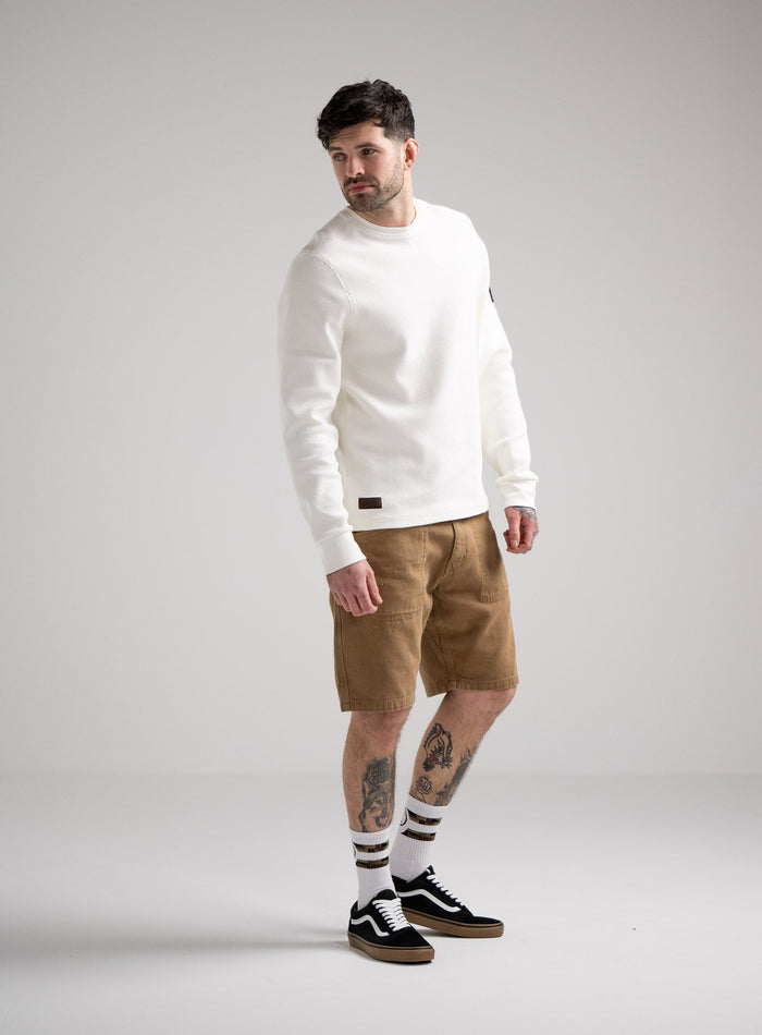 Bernie Is 6ft And Wears Size: M | Hem Studio Image Of Model Wearing Dissident Waffle Long Sleeve T-Shirt In Optic White (SS Model)