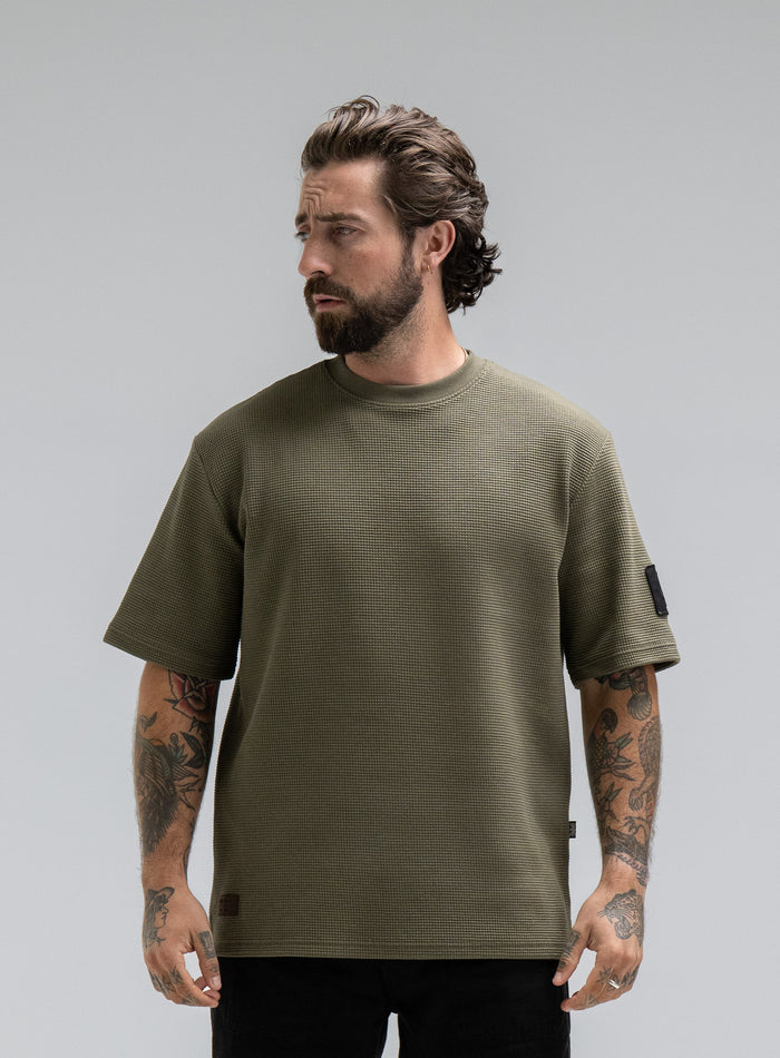 Max Is 5ft 8" And Wears Size: M | Hem Studio Image Of Model Wearing Dissident Waffle Short Sleeve T-Shirt In Khaki (SS Model)