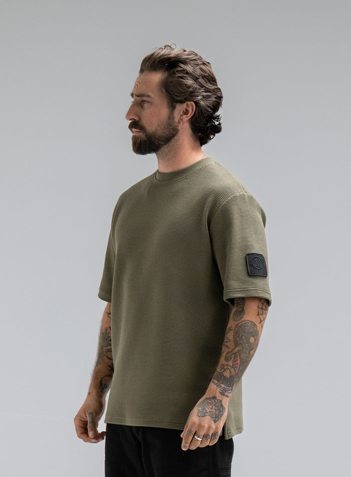 Max Is 5ft 8" And Wears Size: M | Hem Studio Image Of Model Wearing Dissident Waffle Short Sleeve T-Shirt In Khaki (SS Model)