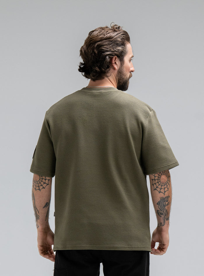 Max Is 5ft 8" And Wears Size: M | Hem Studio Image Of Model Wearing Dissident Waffle Short Sleeve T-Shirt In Khaki (SS Model)
