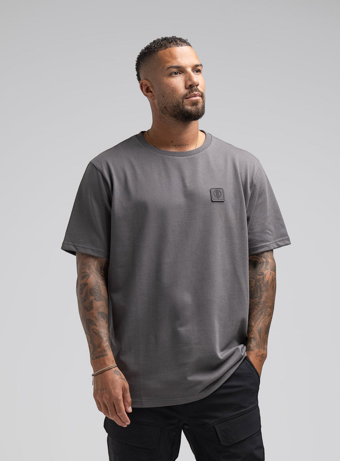 Dj Is 6ft 4" And Wears Size: Xl | Hem Studio Image Of Model Wearing Enigma Oversized Tee In Grey (SS Model)