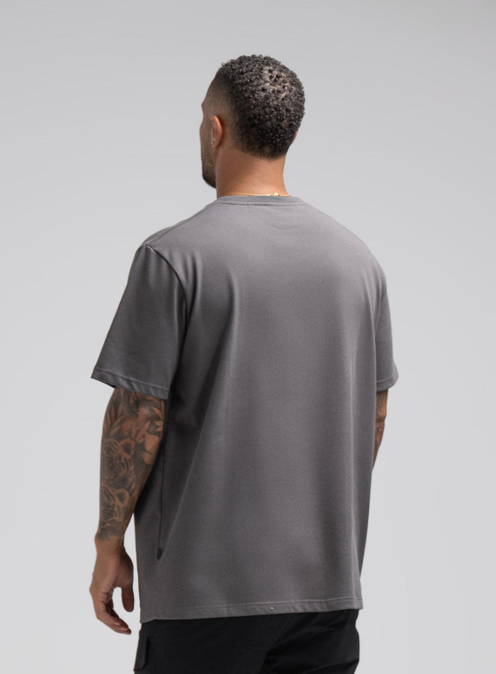 Dj Is 6ft 4" And Wears Size: Xl | Hem Studio Image Of Model Wearing Enigma Oversized Tee In Grey (SS Model)