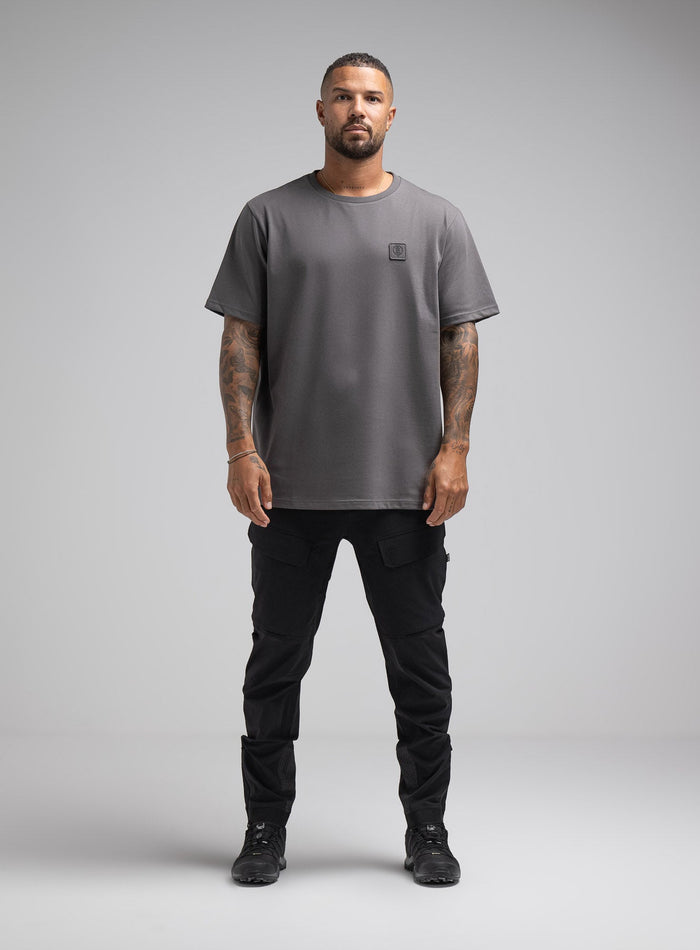 Dj Is 6ft 4" And Wears Size: Xl | Hem Studio Image Of Model Wearing Enigma Oversized Tee In Grey (SS Model)