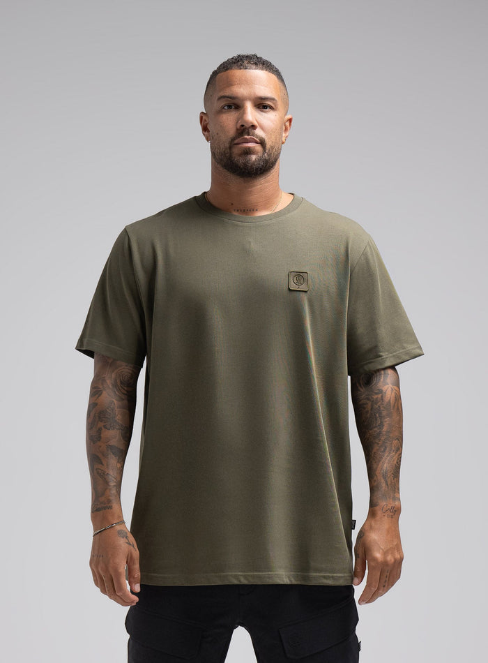 Dj Is 6ft 4" And Wears Size: Xl | Hem Studio Image Of Model Wearing Enigma Oversized Tee In Khaki (SS Model)