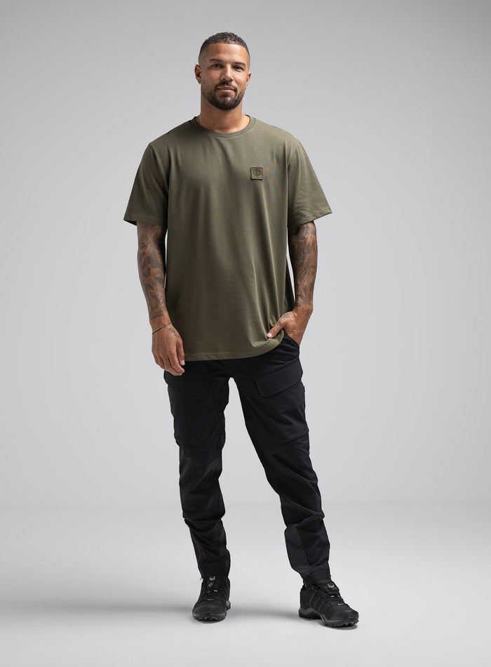 Dj Is 6ft 4" And Wears Size: Xl | Hem Studio Image Of Model Wearing Enigma Oversized Tee In Khaki (SS Model)