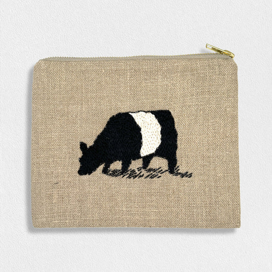 The FEARRINGTON LIFESTYLE COLLECTION - SIGNATURE BELTIE LINEN POUCH by CITRUS FASHIONS is a small beige pouch with a gold zipper, hand-stitched with a black and white grazing cow—ideal for carrying cosmetics.