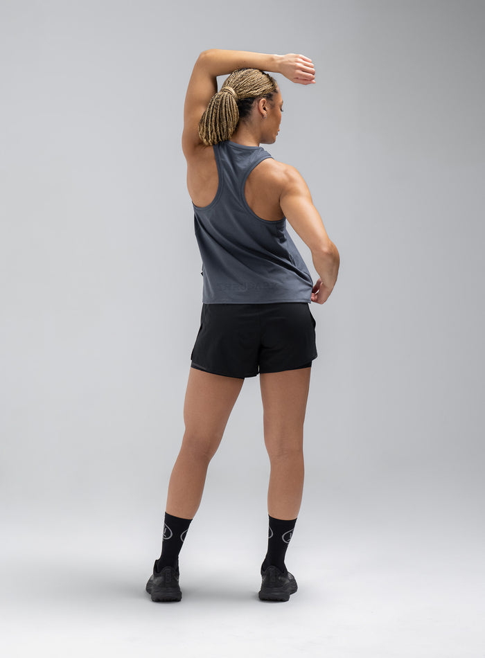 Jade Is 5ft 8" And Wears Size: S | Hem Studio Image Of Model Wearing Force Drirelease® Tank Vest In Storm Blue (SS Model)