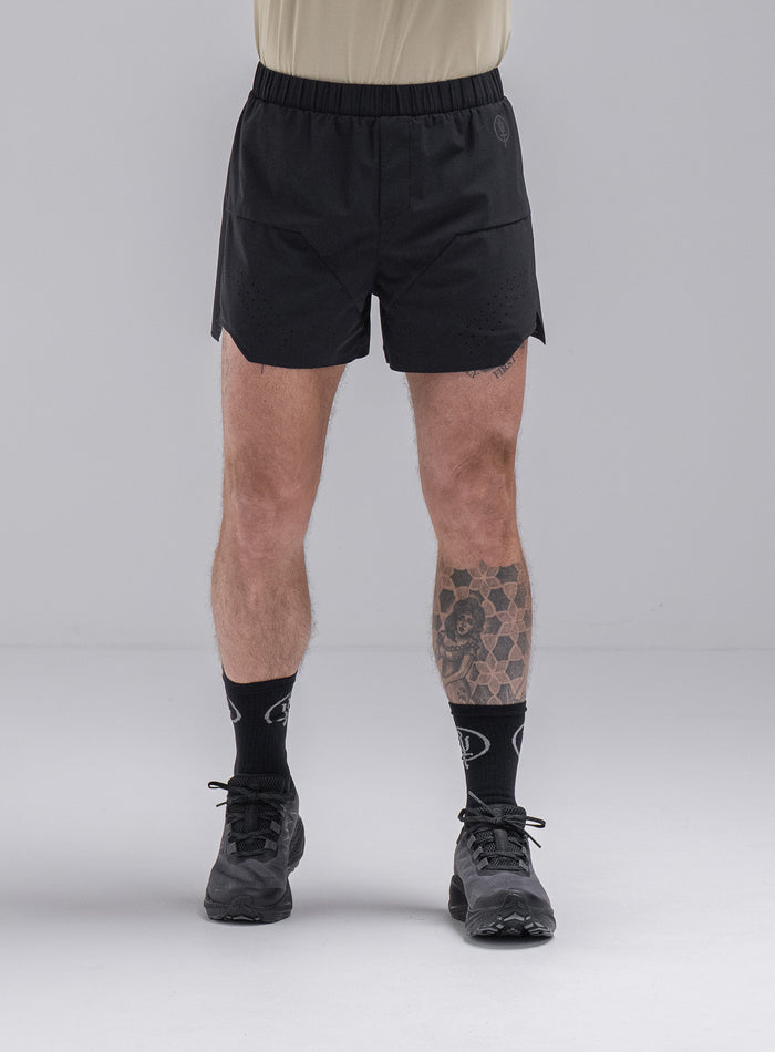 Chez Is 6ft And Wears Size: M | Hem Studio Image Of Model Wearing Force Trail Running 4” Shorts In Obsidian Black (SS Model)