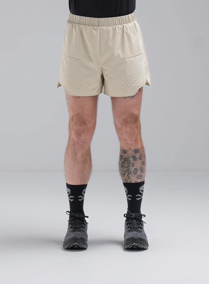 Chez Is 6ft And Wears Size: M | Hem Studio Image Of Model Wearing Force Trail Running 4” Shorts In Stone (SS Model)