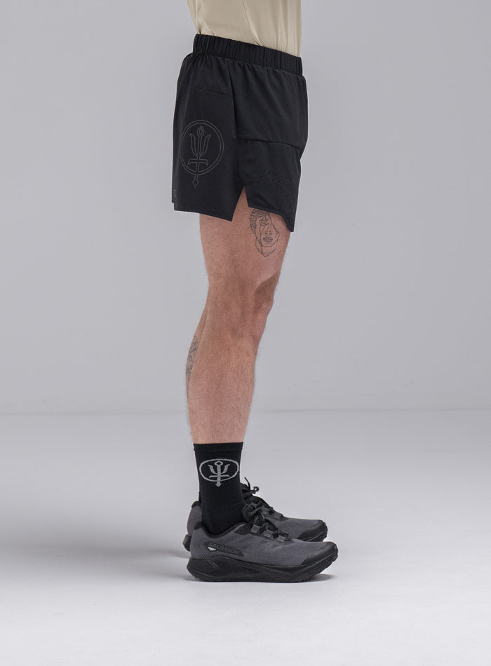 Chez Is 6ft And Wears Size: M | Hem Studio Image Of Model Wearing Force Trail Running 4” Shorts In Obsidian Black (SS Model)