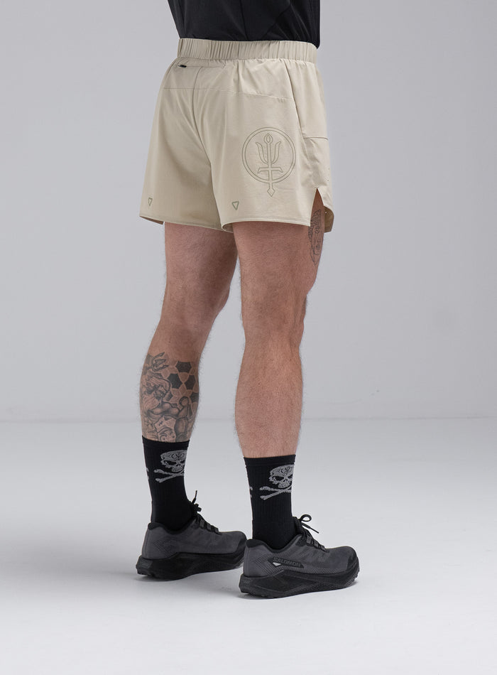Chez Is 6ft And Wears Size: M | Hem Studio Image Of Model Wearing Force Trail Running 4” Shorts In Stone (SS Model)